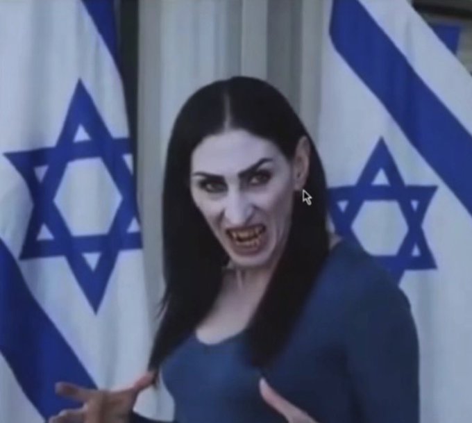 A digitally altered image shows a woman with sharp vampire-like fangs and pale skin standing in front of two Israeli flags.