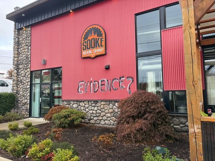 gddub's tweet photo. BREAKING: Someone spray painted "Evidence?" on the side of the Sooke Brewing building in BC where buddy got fired for wearing the wrong T-shirt on Truth and Reconciliation day. https://t.co/HW6N8flIYV