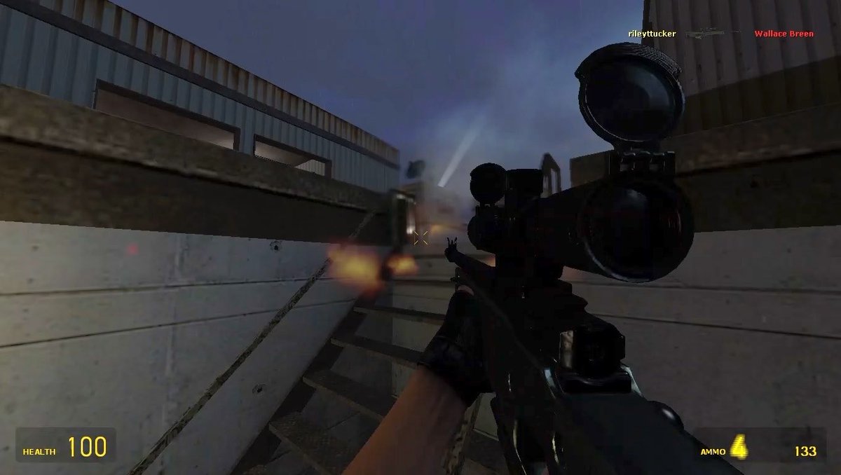 A first-person screenshot from a video game shows the player holding a scoped rifle on a wooden walkway, with a fire burning in the distance; the HUD displays Health 100 and Ammo 133, and the name 'Wallace Breen' appears in red text in the upper right.
