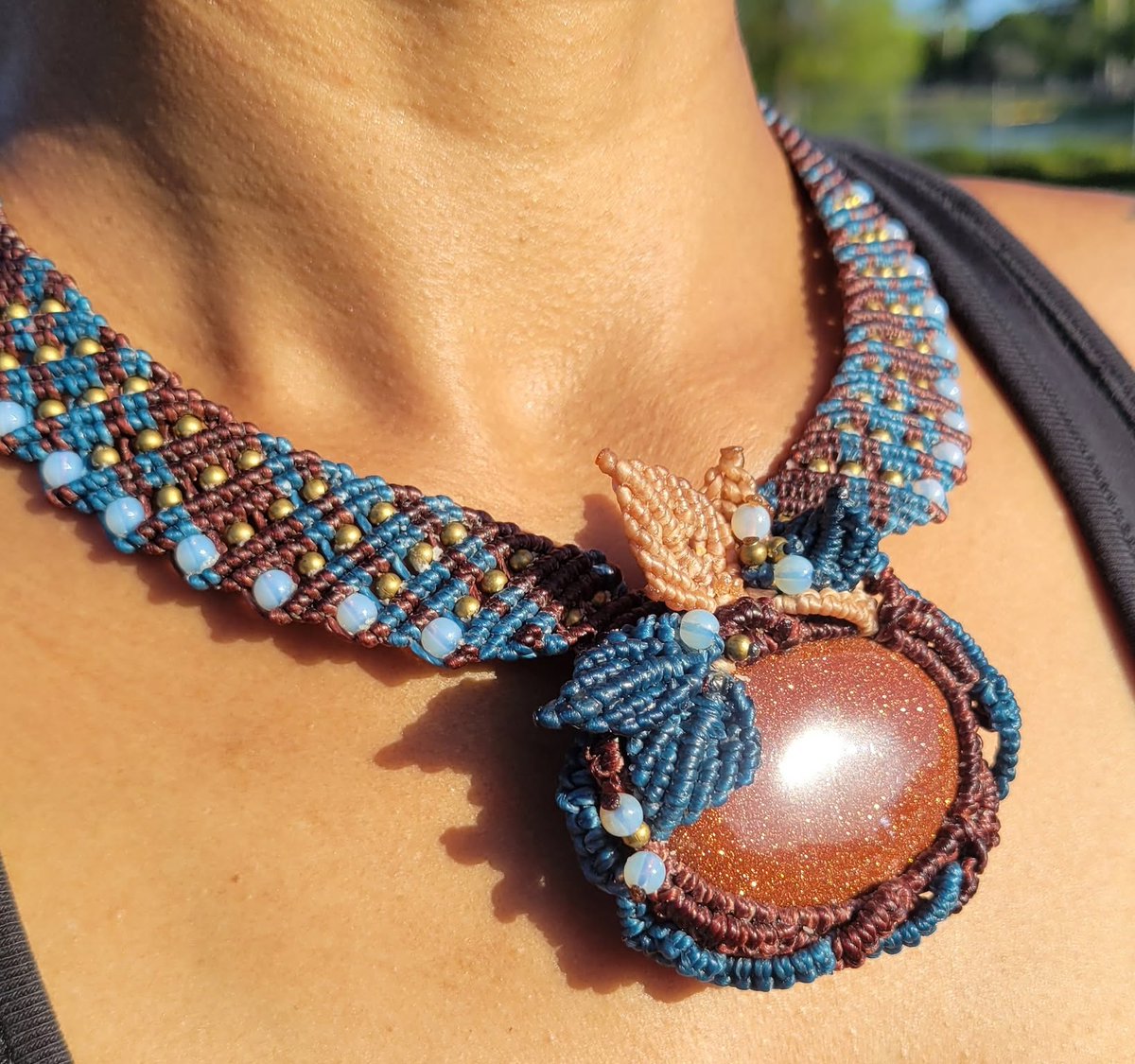 nilton1000's tweet photo. More time in my quiet home studio has opened space to explore new macramé techniques with calm, joy, and curiosity. This Golden Sandstone pendant, wrapped in beige and blue leaves, reflects that creative freedom. https://t.co/O8qZefQien