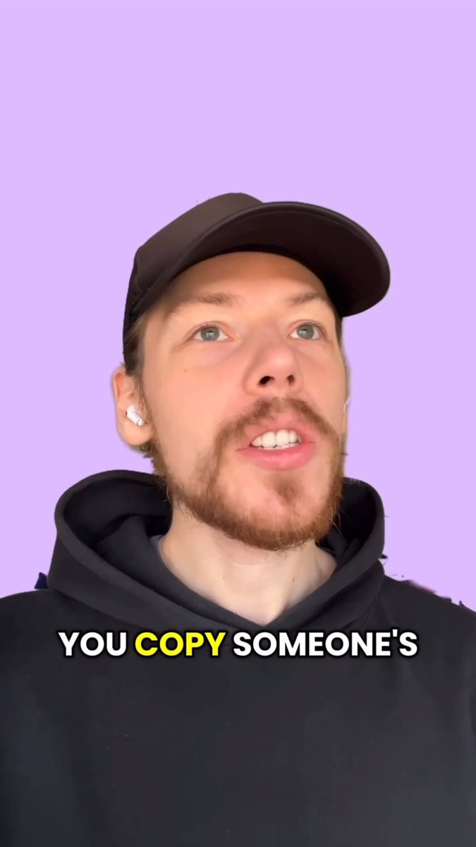 A man with a beard, wearing a black cap, hoodie, and wireless earbuds, speaking to the camera against a purple background with the caption 'YOU COPY SOMEONE'S'.