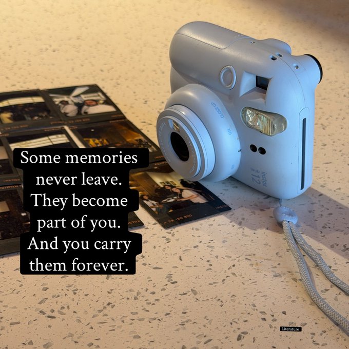 A light blue instant camera sitting on a speckled countertop next to printed photos, with a caption: "Some memories never leave. They become part of you. And you carry them forever."