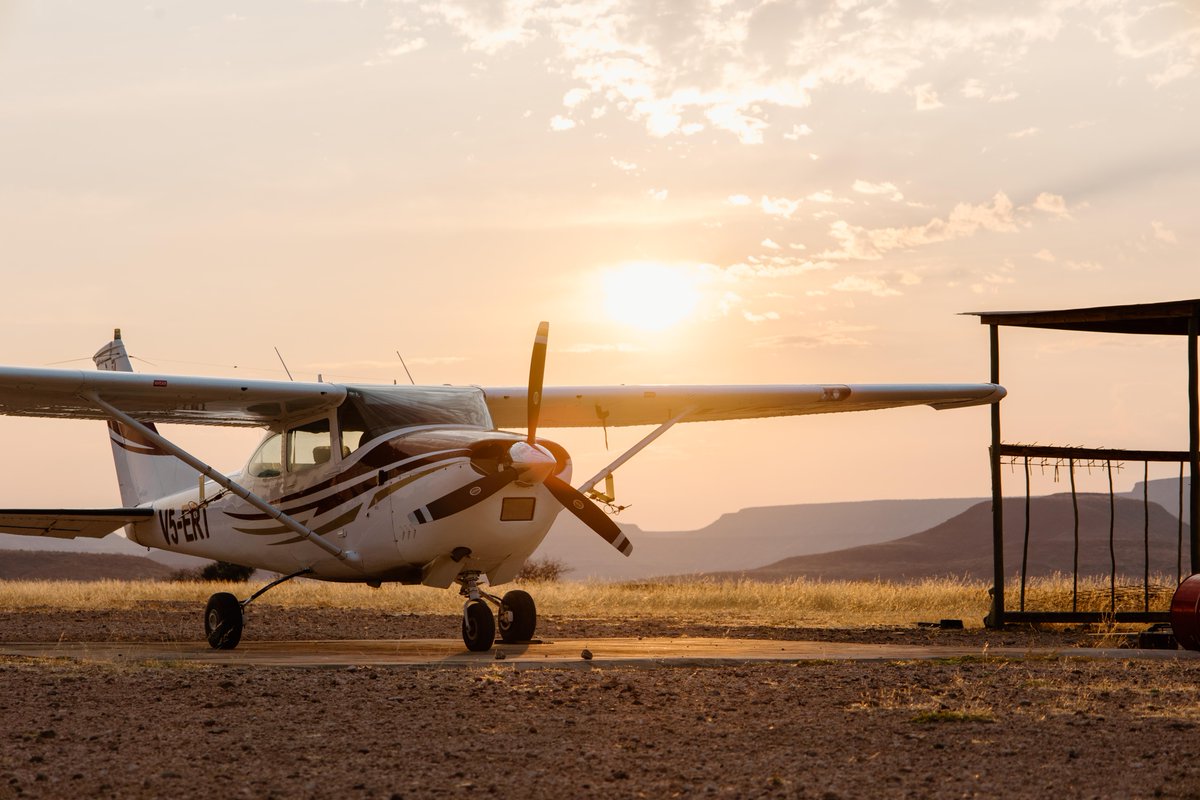 SRTNamibia's tweet photo. As the sun rises over Namibia’s vast wilderness, the day begins from above.  An early morning flight takes to the skies to track and monitor black rhinos across the remote landscapes they call home. A different perspective on the vital work of protecting Namibia’s black rhino. https://t.co/820RSjpBjT