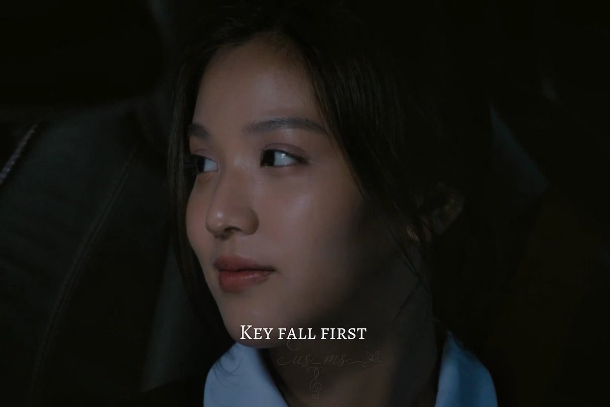 A close-up cinematic shot of a young woman with dark hair looking off to the side in a dimly lit setting, featuring the text 'KEY FALL FIRST' overlaid on the image.