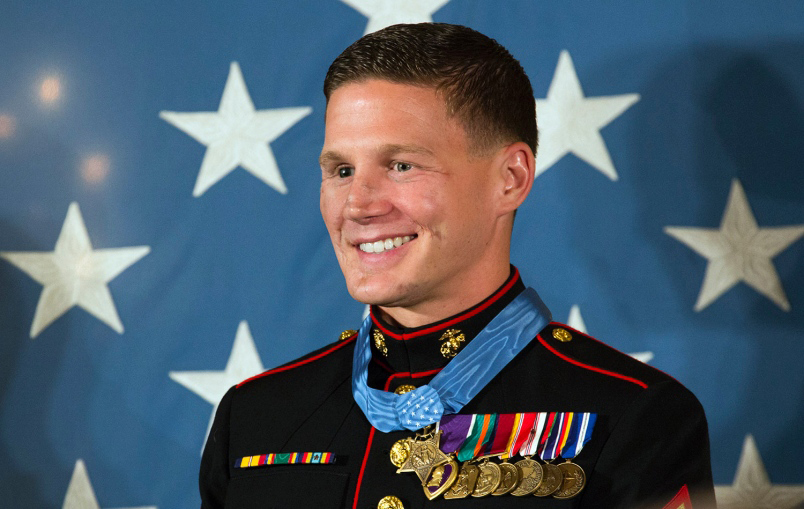 FinalTelegraph's tweet photo. True Story: 

On November 21, 2010, twenty-one-year-old Marine Lance Corporal Kyle Carpenter was stationed on a sandbagged rooftop outpost in Marjah, Helmand Province, Afghanistan. During an insurgent attack, an enemy hand grenade bounced onto the roof, landing directly between Carpenter and his fellow Marine, Lance Corporal Nick Eufrazio. Without hesitation, Carpenter threw his body directly over the grenade to shield his friend from the blast.

The explosion shattered his body: his right eye was destroyed, his lower jaw was blown away, his collarbone and right arm were broken in dozens of places, and his heart stopped. When the medical evacuation flight landed at Camp Bastion, medics initially classified him as P.E.V. (Patient Expired Upon Arrival). He flatlined three separate times, but doctors and corpsmen refused to give up, reviving him against all odds.

Carpenter was flown to Walter Reed National Military Medical Center, where he spent roughly three years enduring 40 surgeries. Throughout his hospitalization, his mother, Robin, rarely left his side, sleeping in a chair next to his bed for months.

The physical recovery was grueling, but the emotional low point came months into his rehabilitation. Carpenter was sitting up in bed attempting to eat a bowl of cereal by himself. Because severed facial nerves left his mouth and chin completely numb, milk spilled across his chest. Looking into a mirror at his altered face, he broke down weeping and asked his mother, "Who is ever going to love me again?"

His mother held his face in her hands and reminded him of his faith: God had kept him alive for a distinct reason, his value was defined by his character rather than his scars, and true family and community would always love him unconditionally.

Rather than turning to cynicism or viewing himself as a victim, Carpenter adopted an uncompromising mindset of gratitude, referring to the rest of his life as "the bonus round". He retrained his body, completed the Marine Corps Marathon, earned a four-year college degree from the University of South Carolina, and was awarded the Medal of Honor.