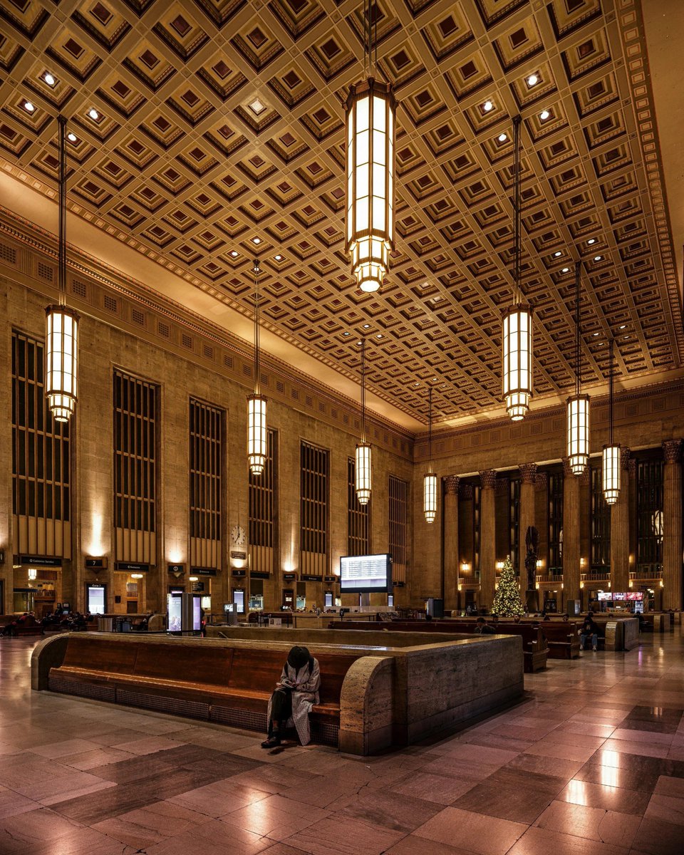 gietzschean's tweet photo. The grand interior of Philadelphia’s 30th Street Station, completed in 1933. 

Its Art Deco grandeur comes through in the soaring five-story windows, monumental pendant chandeliers, and vast coffered ceiling; a transport station designed to feel like a civic monument. https://t.co/haTHjUAwqj