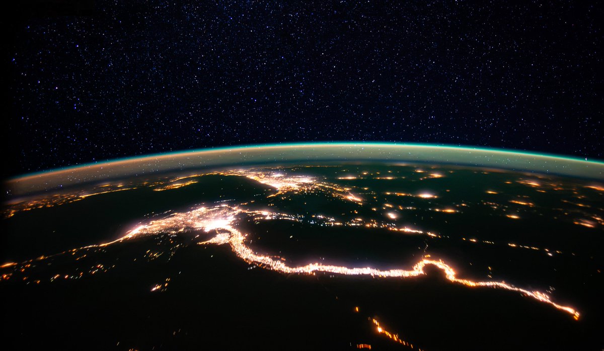 astro_Pettit's tweet photo. Riverside lights of the Nile beneath a starry sky. I took this photo in 2012 when the majority of the lights were still sodium vapor, creating a thin golden glow that stretched from Alexandria to Aswan. One of the most striking nighttime views from orbit! https://t.co/Sq5tToNQ3r