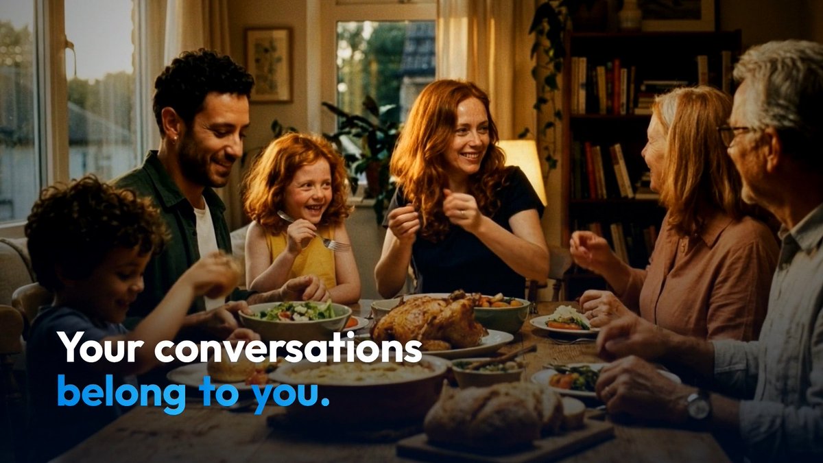 A promotional image showing a multi-generational family gathered around a dinner table with the text 'Your conversations belong to you.' overlaid in white and blue.