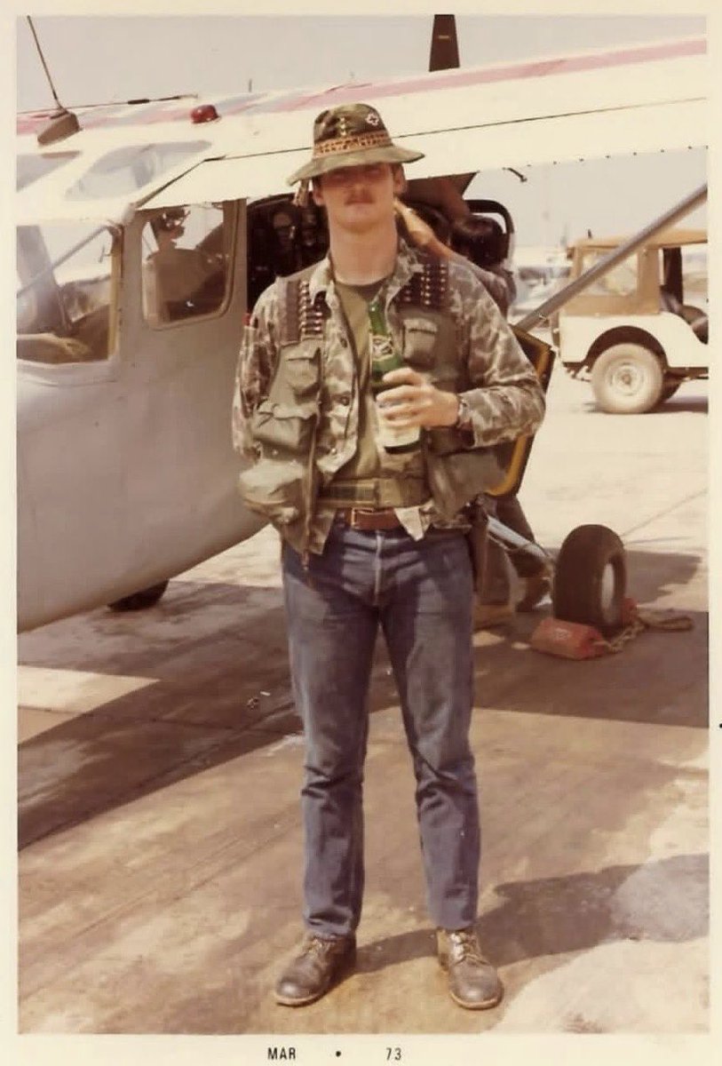 AircraftJunky's tweet photo. RAVEN 25 — THE AIR FORCE PILOT WHO WASN’T SUPPOSED TO BE THERE

The date beneath this photograph reads March 1973.

The man is Captain Darrel D. Whitcomb. Behind him is an unmarked O-1 Bird Dog. There is no uniform, visible rank or American flag, because officially, Whitcomb was not fighting a war in Laos.

A 1969 Air Force Academy graduate, Whitcomb had already flown the C-7 Caribou in Vietnam before returning as an OV-10 forward air controller known as Nail 25. Then he volunteered for the classified Steve Canyon Program and became Raven 25.

The assignment meant surrendering his military identification, changing into civilian clothes and entering Laos under embassy cover. Operating from Long Tieng, Whitcomb supported General Vang Pao’s CIA-backed Hmong army, flying low over the Plain of Jars to locate enemy forces, mark targets and direct American, Lao and Hmong aircraft onto them.

During an NVA attack on Skyline Ridge, friendly troops were caught in an ambush. Whitcomb repeatedly exposed his Bird Dog to enemy fire while directing strikes dangerously close to the men below. AK-47 rounds eventually tore through the aircraft’s oil system and killed the engine. He still managed to dead-stick the crippled O-1 back into Long Tieng.

The mission earned him the Silver Star.

Whitcomb was also photographed with Hmong T-28 pilot Touxiong Lee, whom he credited with saving his life during another mission, a reminder that the Ravens survived because Lao and Hmong airmen fought beside them.

After Raven operations ended, Whitcomb returned to the OV-10 and continued flying over Cambodia. On August 15, 1973, he was given the honor of being the last aircraft in his four-ship formation to land as America’s combat-air campaign there ended.

He later retired as an Air Force colonel and Delta international captain. But here he remains Raven 25: a young American pilot in civilian clothes, standing beside an aircraft without a flag, at the end of a war his country spent years pretending it was not fighting.

#AircraftHistoryJunky #RavenFAC #Raven25 #DarrelWhitcomb #SecretWar #LongTieng #O1BirdDog #Project404 #AviationHistory