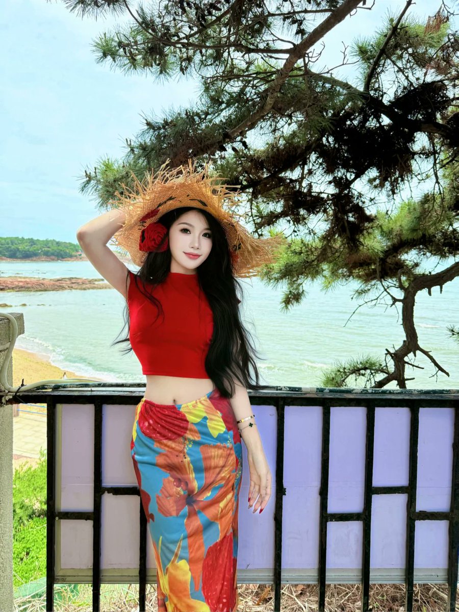 sweetiesprite's tweet photo. Coastal summer vibe 🌊 Vibrant red cropped top with lace-up back &amp; colorful floral wrap skirt. Straw hat and ocean view, hot summer by the sea.
#BeachVibes #SummerOOTD #CoastalStyle https://t.co/AjaX0bHyV8