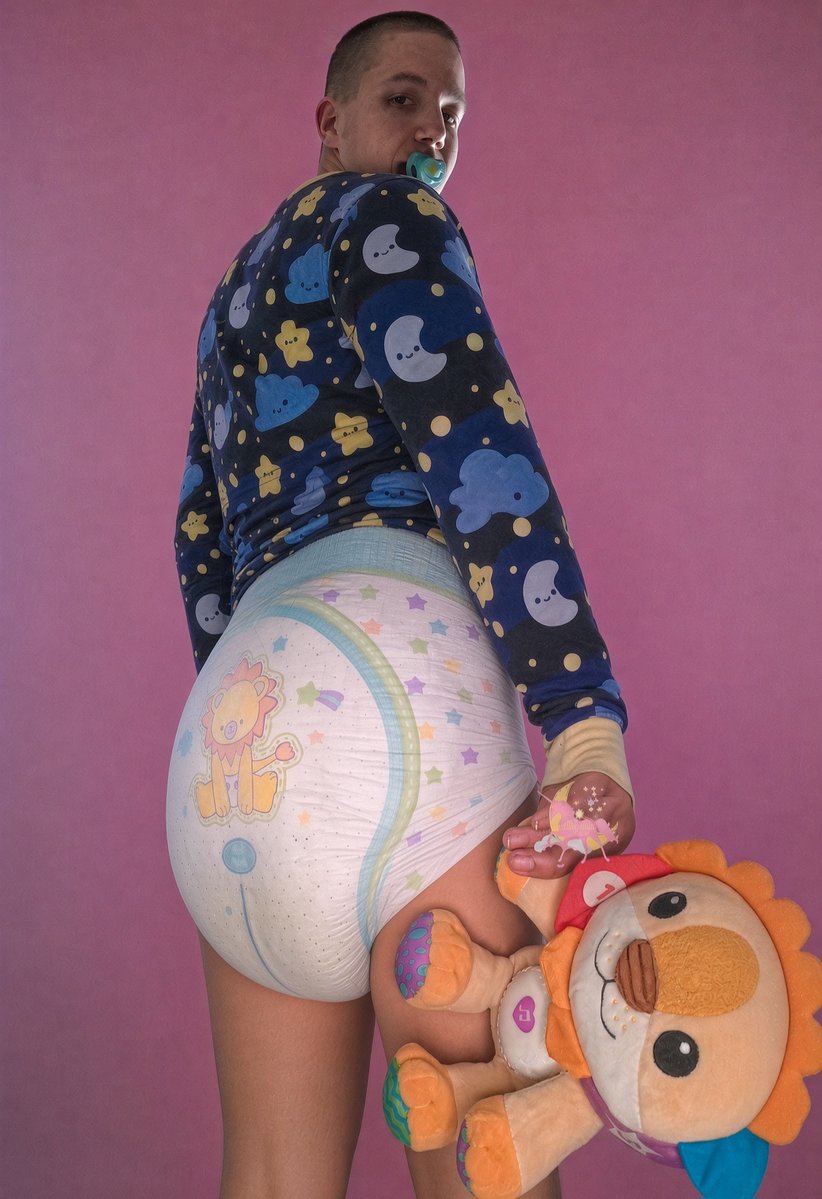 Diaper_Exposed's tweet photo. Adult in a star-print onesie, pacifier in his mouth, a lion-print diaper looking well used, and a stuffed toy jammed between his thighs. He turns around like he’s waiting to be changed. TG: J_trkk. Come tell him he’s ridiculous  he looks like he likes it.
#diaper #loser #exposed https://t.co/M6jH3QGqS2