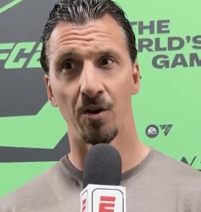 A man with a goatee being interviewed by ESPN, with an FC24 gaming backdrop that reads 'THE WORLD'S GAME'.