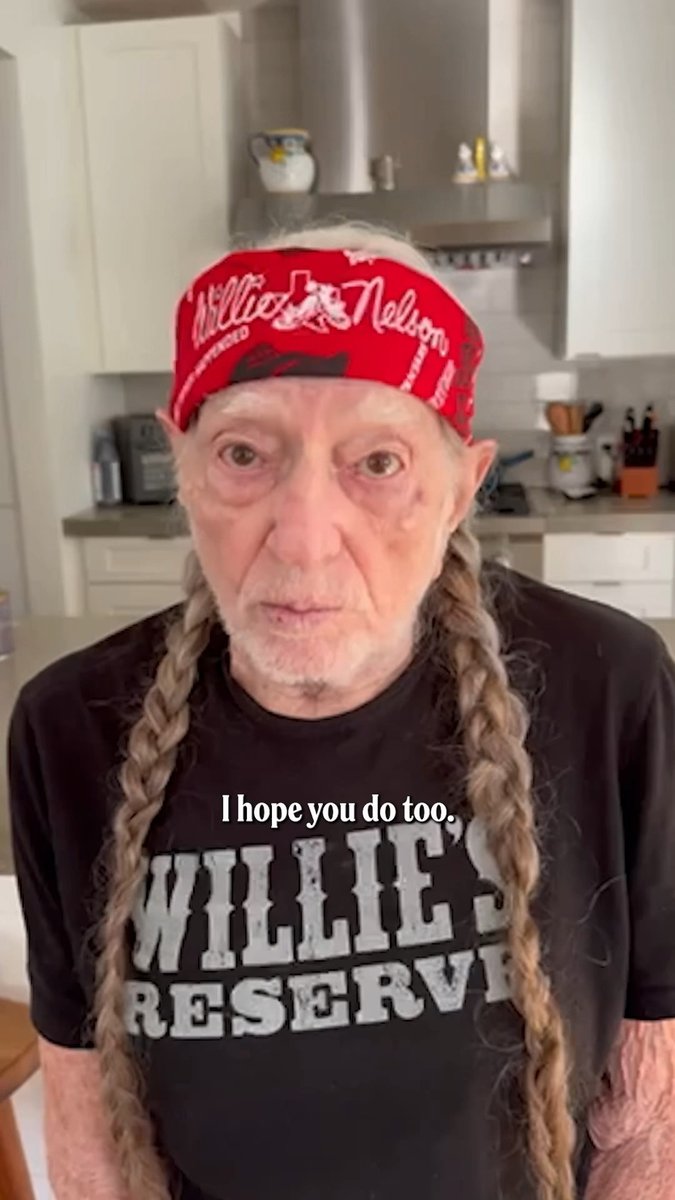 An elderly man wears a red "Willie Nelson" bandana and a black "Willie's Reserve" t-shirt in a kitchen, with the caption "I hope you do too," overlaid on the image—delivering a message tied to the post urging viewers to vote in the upcoming election.