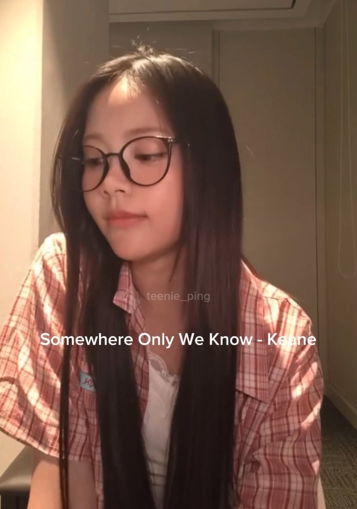 A young woman with long dark hair and round glasses wearing a pink plaid shirt, with text overlay reading 'Somewhere Only We Know - Keane' and watermark 'teenie_ping'.