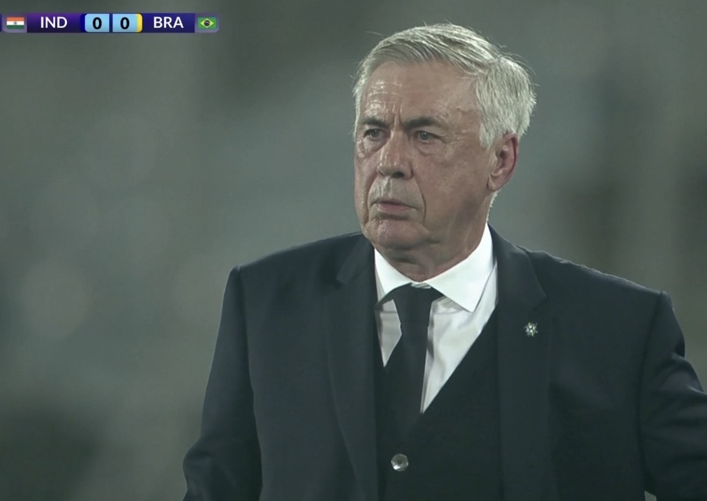 TrollFootball's tweet photo. Forget Estevão and Samuel Lino, today's man of the match was Ancelotti, for surviving the Indian heat and humidity in a three piece suit. https://t.co/V6giYPFxhm