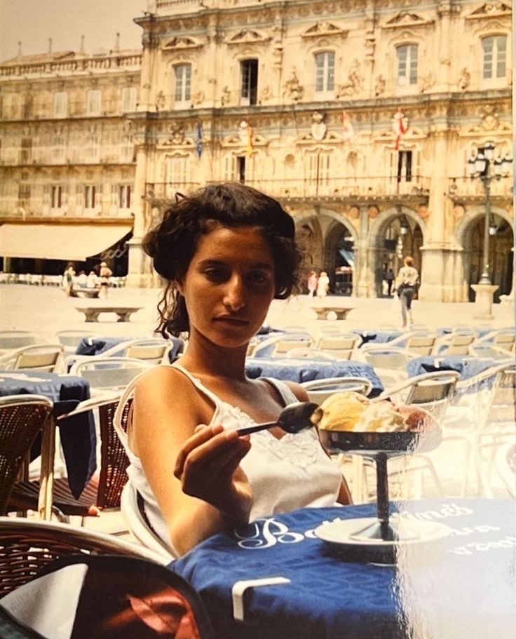 Magicalspain's tweet photo. Woman enjoying an ice cream at an outdoor cafe. Salamanca, early 1990s. https://t.co/K8DtHkhKdY