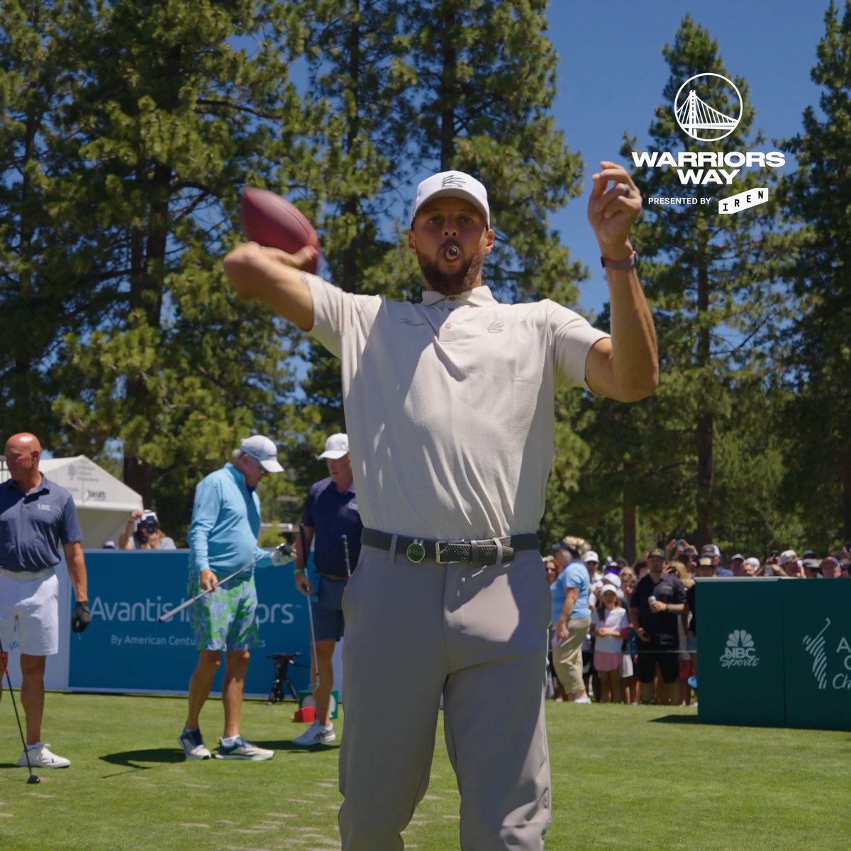 Stephen Curry throws a football on a golf course at what appears to be an American Century Championship event, with "WARRIORS WAY presented by IREN" branding in the corner alongside NBC Sports and Avantis Investors signage, promoting the latest offseason episode of the Warriors' behind-the-scenes series.