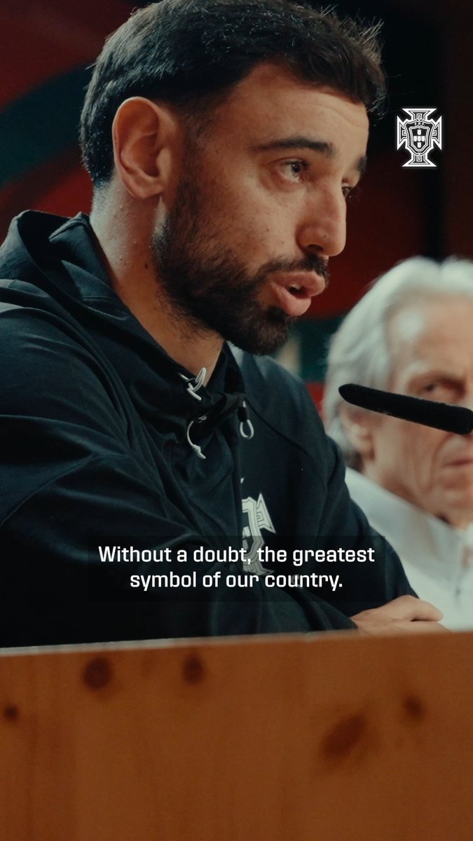 A bearded man in a dark jacket speaks into a microphone, accompanied by the text "Without a doubt, the greatest symbol of our country," with the Portuguese Football Federation logo in the corner.