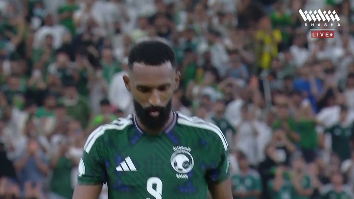 Firas Al-Buraikan, wearing the Saudi Arabia #9 jersey, walks away with a disappointed expression after missing a penalty kick during the Gulf 27 matches broadcast live on Shasha.