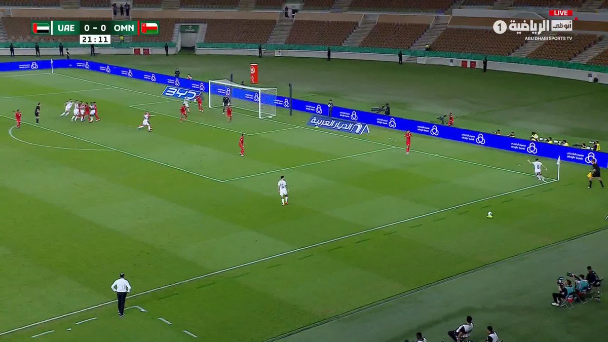 The image shows a football match between UAE and Oman at the Arabian Gulf Cup, with UAE leading 1-0 at 21:11 after Othman Kamara's header found the back of the Omani net, as broadcast live on Abu Dhabi Sports TV. Players in red and white kits are visible on the pitch following the goal, with a free kick setup near the goal area.