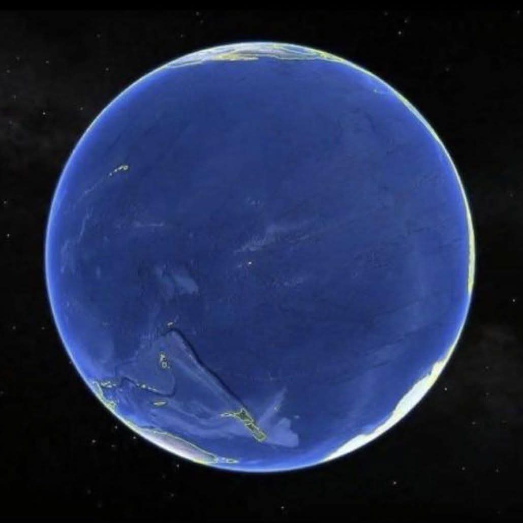 konstructivizm's tweet photo. This is the face of Earth we almost never see from the ground: the Pacific, an ocean so wide it covers nearly a third of the planet and leaves the other continents crowded along the far rim. From here the world looks less like a map of nations than a single blue expanse, broken only by weather and the thin curve of the horizon.