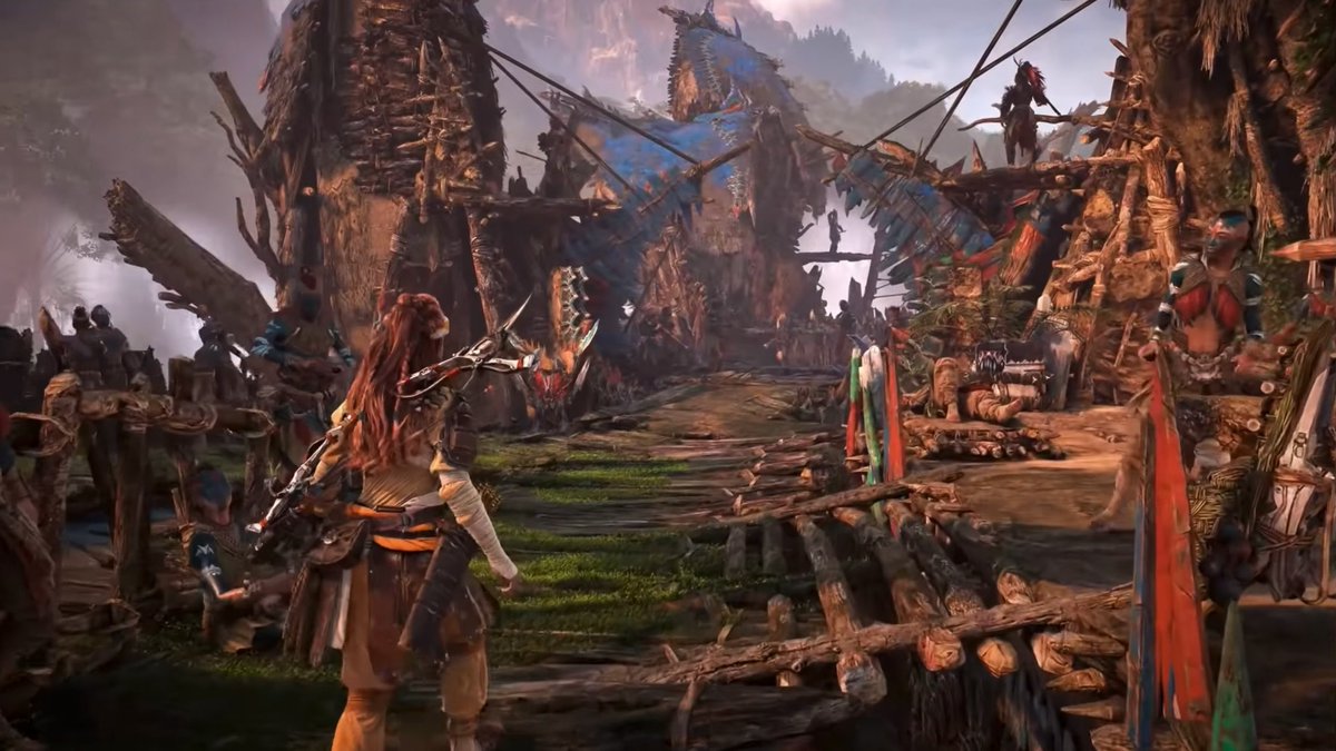The image shows the protagonist Aloy from the video game "Horizon Zero Dawn" standing in a tribal village settlement. The caption relates to the post by depicting a scene from a game, likely referencing a discussion about gameplay or narrative where the commenter is disputing someone's claim about the title.