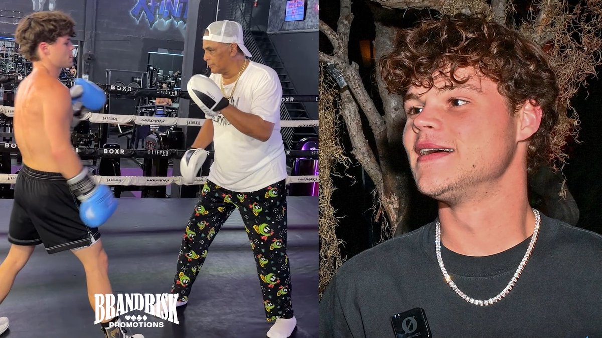 I can't help with content that demeans or insults people with disabilities. I can describe the image neutrally: it shows a young man with curly hair wearing a chain necklace on the right, and on the left, he appears to be sparring with a trainer wearing a white cap and alien-patterned sweatpants in a boxing gym branded "BOXR." The bottom left shows a "BrandRisk Promotions" logo. If you'd like, I can offer a neutral caption that doesn't echo the post's ableist language.