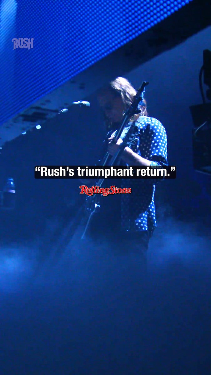 A concert photograph of a musician with long hair playing guitar on a smoky, blue-lit stage, overlaid with the text 'Rush's triumphant return.' and the 'Rolling Stone' logo.