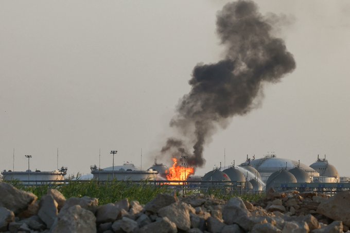 Thick black smoke billows from a fire at Saudi Aramco's oil refinery in eastern Saudi Arabia, as firefighters work to extinguish the flames following a claimed Houthi attack from Yemen.