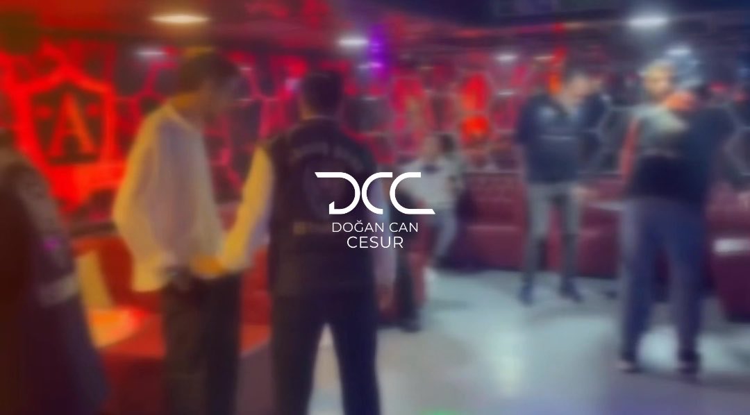 A dimly-lit venue interior with red lighting shows several blurred figures, with the watermark "DCC Doğan Can Cesur" displayed in the center. The image appears to depict the entertainment establishment in Istanbul's Şişli district where police operations led to the detention of hostesses for various licensing violations.