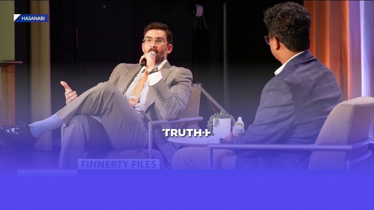 Two men in suits are seated in chairs during a discussion on a stage, with labels reading 'HASANABI', 'TRUTH', and 'FINNERTY FILES' overlaid on the video.