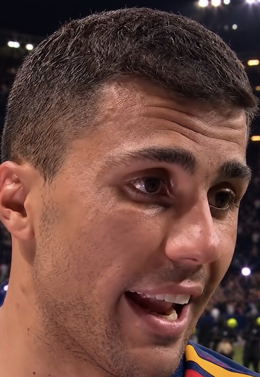 ChinoUTD's tweet photo. 🚨 Rodri on Hansi Flick’s impact:

“People keep asking why Barcelona players go to their national teams and suddenly they’re running everywhere, scoring, creating chances.

I can tell you why.

Hansi doesn’t allow us to relax in training.

I learned under Pep for years, and Pep would stop a training session because somebody was standing two metres in the wrong position.

Hansi will stop it because somebody took two seconds too long to attack the space.

That’s the difference.

I remember one of my first sessions. We had just won the ball and I played it sideways.

Perfect pass. Safe pass.

Hansi blew the whistle.

‘Rodri, why?’

I said, ‘Why what?’

‘Why did you give them time to breathe?’

I looked at him and said, ‘Coach, we only won the ball three seconds ago.’

He said, ‘Exactly. They are not ready yet.’

Then he made us start again.

That sentence stayed with me.

With Pep, I learned how to control a match until the opponent becomes tired of chasing you.

With Hansi, sometimes it feels like he wants the opponent to regret losing the ball before they’ve even realised they’ve lost it.

And training reflects that.

Win it. Look forward.

Someone runs.

Lose it. Run again.

Lamine is running. Gordon is running. Olmo is running. Pedri is running.

Sometimes I look around and think, ‘Does anybody at this club walk?’

Hansi doesn’t care.

He’ll shout, ‘Again!’

Then international break comes and you begin noticing it.

Lamine goes with Spain and scores. I’m getting into positions to score. Olmo is creating. Gordon goes to England and he’s scoring and assisting.

Different national teams, different coaches, different systems.

But you can still recognise certain movements.

That’s when you realise club football follows you home.

I spoke to Gordon once after an England game and joked, ‘You know Hansi isn’t here. You can stop running now.’

He said, ‘I know. I just keep seeing the space.’

That’s Flick.

People think a coach’s work stays at the training ground.

It doesn’t.

If you repeat something every morning for months, eventually you stop waiting for the coach to tell you.

You just see the space and go.

Pep taught me that controlling the ball can control the opponent.

Hansi has reminded me that sometimes the opponent is most vulnerable when nobody controls anything yet.

Maybe that’s why Barcelona players look so electric for their countries right now.

International break changes the shirt.

Apparently it doesn’t switch Hansi Flick off.”