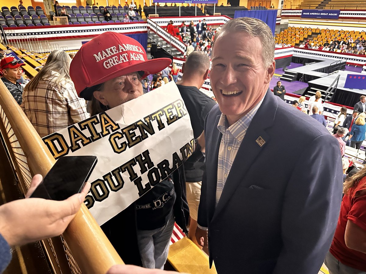 AnnaStaver's tweet photo. Lorain resident Brenda White, who supports data centers, asked for a photo with @SenJonHusted ahead of the #Trump rally. A Husted staffer asked her, “Can we do it without the sign?” She insisted on holding it. https://t.co/gQGNOmIwIY