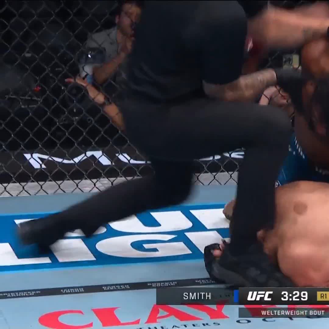 A blurry action shot from a UFC welterweight bout shows a fighter with a black glove, with "SMITH" and "UFC 3:29 R1" visible on the screen overlay.