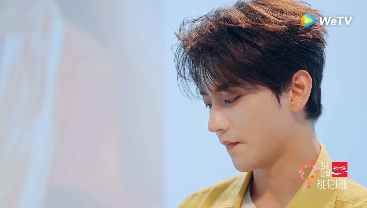 A promotional image for the WeTV series '五十公里桃花塢' (Fifty Kilometers of Peach Blossom Land) shows a young man in a yellow shirt looking downward.