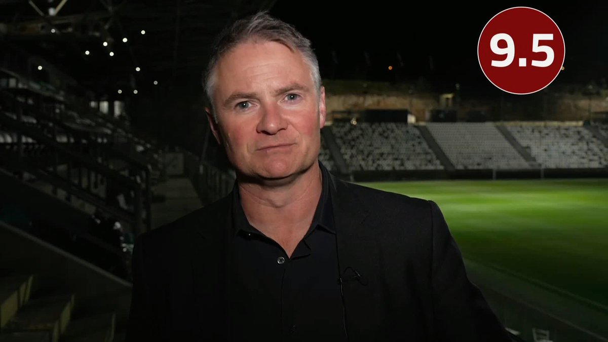 A man in a black suit and shirt is shown in what appears to be a stadium setting, with a "9.5" graphic displayed in a red circle in the top right corner, suggesting a high rating given to an England squad member's performance during the evening's coverage by Rob Dorsett.