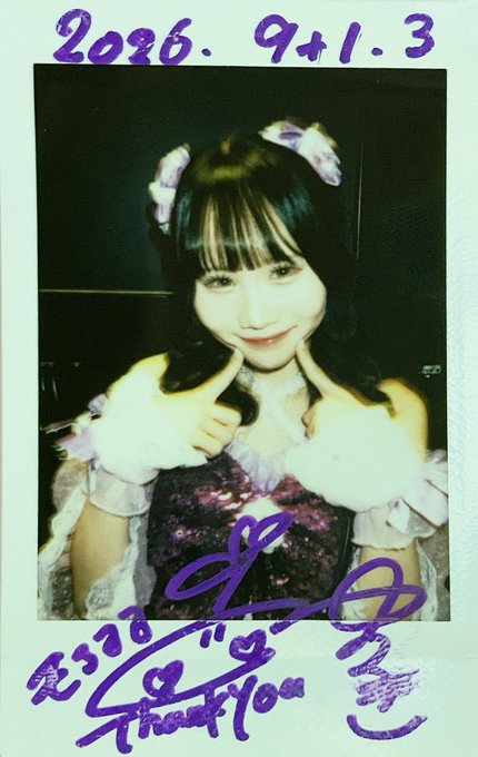 A polaroid-style photo of a smiling young woman with dark hair in pigtails wearing a frilly outfit, dated '2026.9.1.3' at the top and signed 'Ai Toya' (相卜ア) with a heart and 'Thank You' message in purple ink at the bottom.