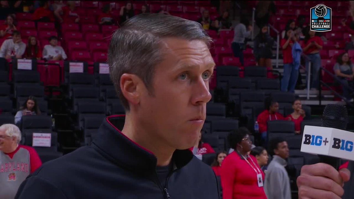 A coach is being interviewed post-match with a B1G+ microphone, with the "B1G Discover Volleyball Challenge" logo visible in the corner. The image likely depicts his reaction to his team's first point scored by Harp, as mentioned in the post.