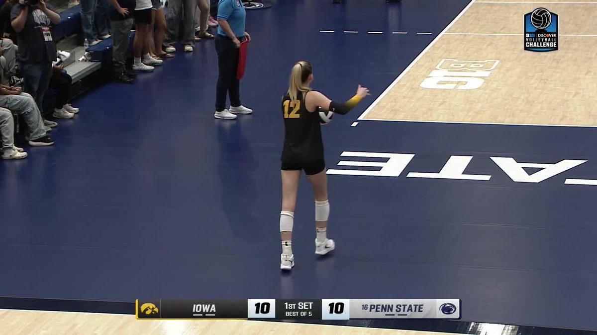 A women's college volleyball match showing player #12 serving, with the scoreboard reading Iowa 10, Penn State 10 in the 1st set during the Discover Volleyball Challenge on the Big Ten Network.