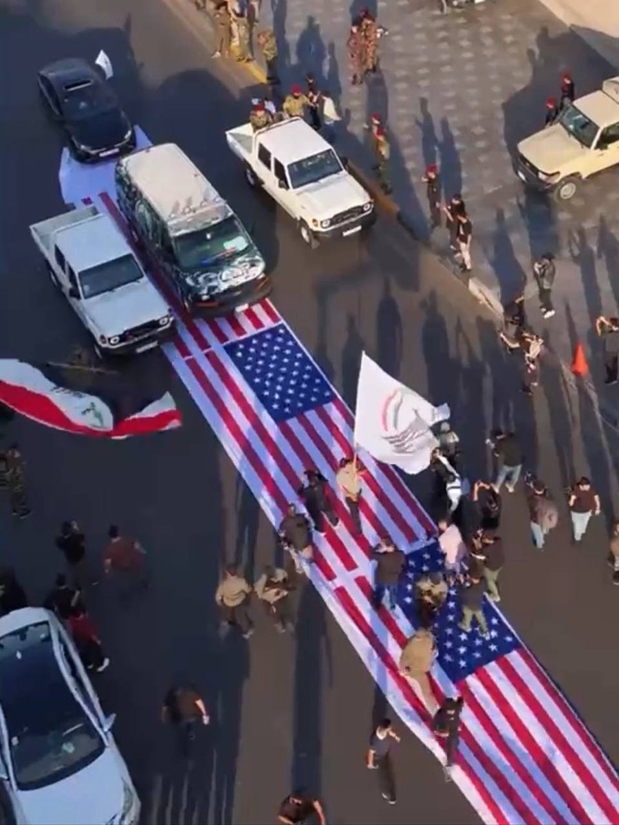 RepJoeWilson's tweet photo. The PMF, an official division of the Iraqi government’s security services, is seen desecrating the U.S. flag out of disrespect and praising the murderous regime in Iran. 

If you needed any more proof that Iraq is an Iranian province… @IraqiPMO Zaidi is this what you think of America?  

Free Iraq from Iran