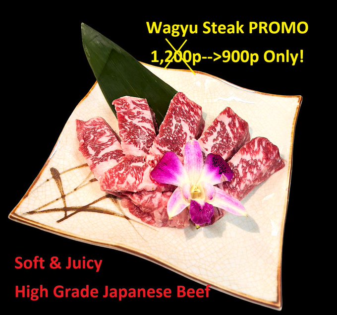 An advertisement for 'Wagyu Steak PROMO' showing raw, marbled Japanese beef on a plate with an orchid, offering a discount from '1,200p-->900p Only!' and labeled 'Soft & Juicy High Grade Japanese Beef'.