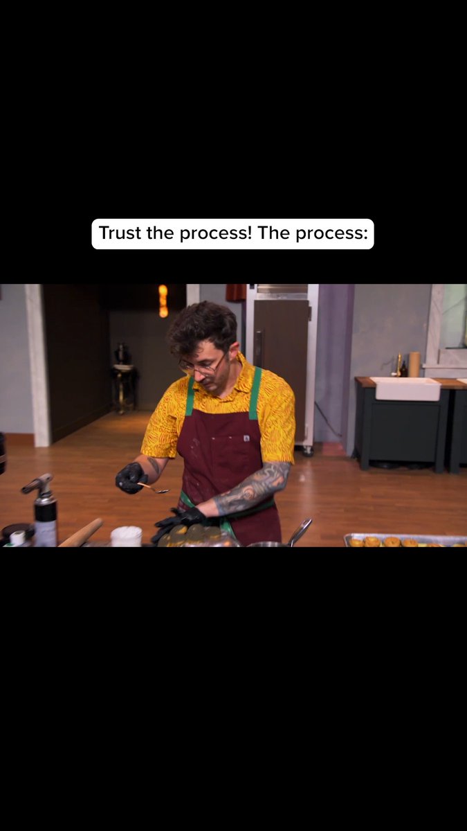 A man with glasses, a yellow patterned shirt, and a maroon apron cooking in a kitchen, with a text overlay reading "Trust the process! The process:"