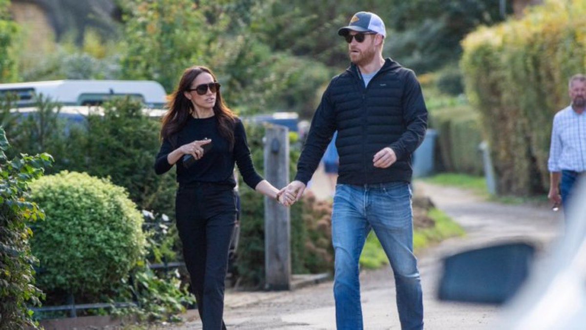 hilltopjennifer's tweet photo. Nobody in California ever bought the act, so now Harry and Meghan are back in the UK pretending that the last six years didn’t happen. Pub lunch in the Cotswolds, fish and chips, the whole ‘we’re just a couple of locals’ routine. Harry wearing his obligatory cap to hide his balding head, instead of owning it like his brother does. You couldn’t script a more pathetic, shameless comeback.
And look at Harry’s ‘dainty’ hand. She’s got his delicate fingers locked in, but his hand is just hanging there. Not closed, not holding hers back. The body language of a man being walked to a photo op he already regrets. 
The press tried to frame this as ‘romantic’ - as if we can’t see what it REALLY is. 
Looks more like coercive control or a straight up act for the benefit of the hired photographer to me.