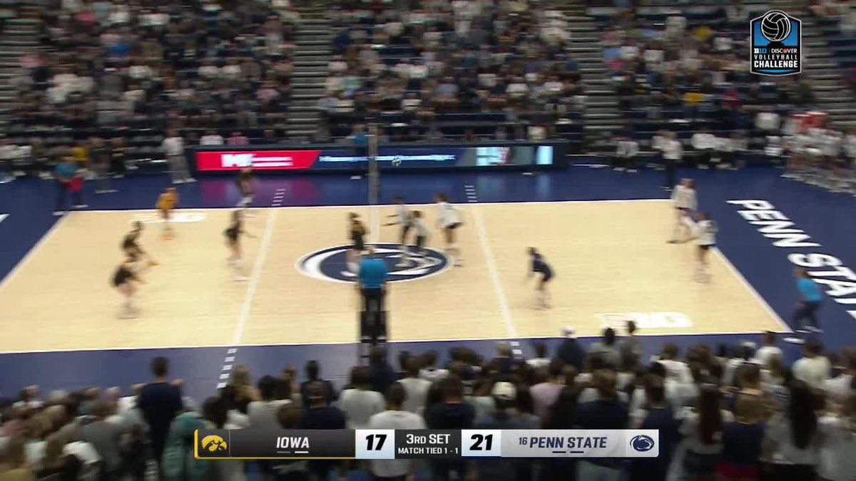 A volleyball match between Iowa and Penn State at a B1G Discover Volleyball Challenge event, with the scoreboard showing Iowa 17, Penn State 21 in the 3rd set with the match tied 1-1.
