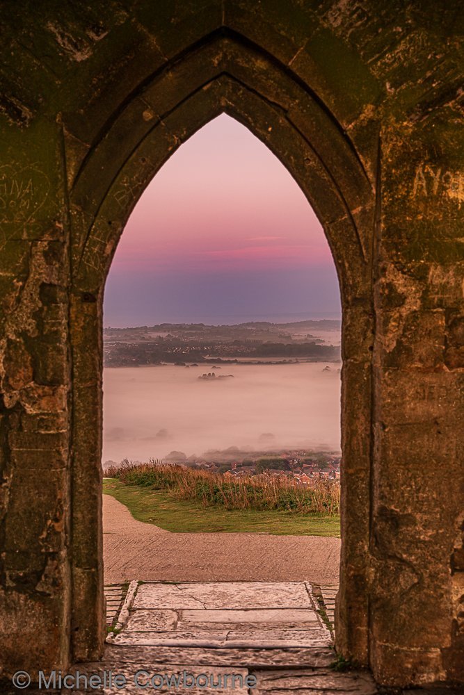 Glastomichelle's tweet photo. Mystical archway. Photo from St Michael's tower on Glastonbury Tor. Good luck to everyone trying for @glastonbury tickets today. 🤞#Glastonbury #glastonburytor https://t.co/KMeH5bZ66K