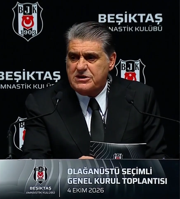 An older man with grey hair in a black suit speaks at a press conference for Beşiktaş Jimnastik Kulübü, with text indicating an Extraordinary Elective General Assembly Meeting on October 4, 2026.