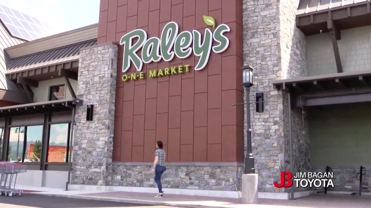 Exterior view of a Raley's O-N-E Market storefront with stone and wood facade; a watermark reads 'JB Jim Bagan Toyota'.
