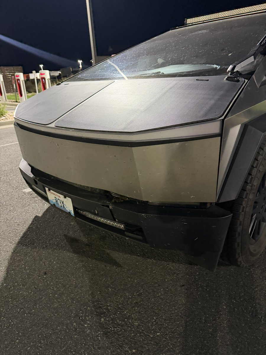 ThePilotNomad's tweet photo. Well… R3X 🦖 met a deer tonight at about 50 mph. FSD saw it and started slowing, but not aggressively enough. By the time I took over and got hard on the brakes, there simply wasn’t enough distance left. Impact felt shockingly mild from inside the truck. No airbags, I’m completely okay, and R3X drove away under its own power. The truck needs some love now: driver-side light, front bumper/fascia and dented front frunk stainless. 📐🦖 Two animals and one truck in one week was definitely NOT on my bingo card. 😔