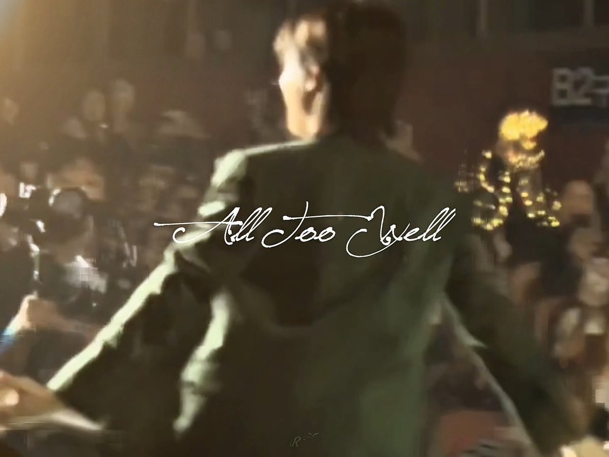 The scene shows a person with shoulder-length dark hair, seen from behind, wearing a dark green jacket, seated in what appears to be a dimly lit bar or lounge with warm ambient lighting. Overlaid across the image is the handwritten-style text "All Too Well," likely referencing the song tied to the #jungji caption about the intimacy of an embrace.