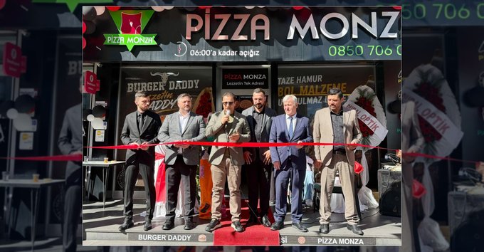A photograph of a ribbon-cutting ceremony at a 'PIZZA MONZA' and 'BURGER DADDY' restaurant, showing six men in suits cutting a red ribbon outside the entrance.